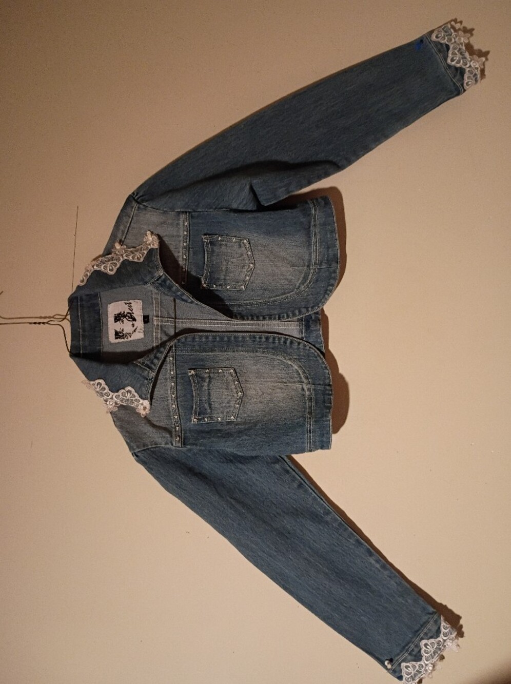C'est Cropped Denim Jacket with Lace Trim.